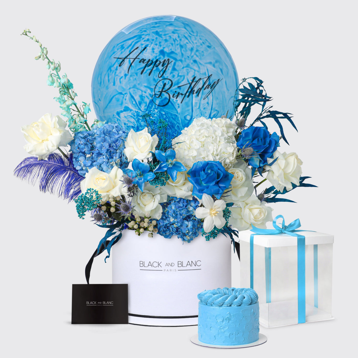 Floral arrangement in white container with blue balloon, cake, and gift box in Azure Birthday Set