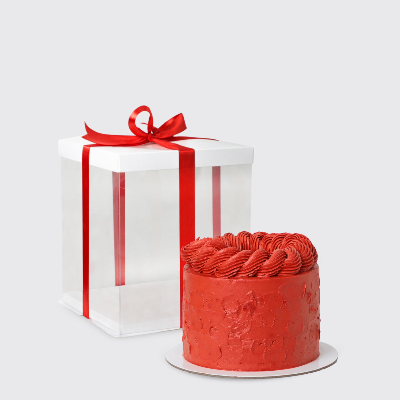 Red frosted cake with decorative swirls for Cartier Crimson Luxury Set