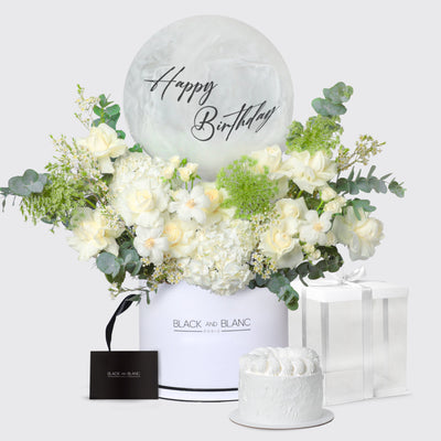 Elegant floral arrangement in a white box with Happy Birthday message and small cake from Cecile Birthday Set