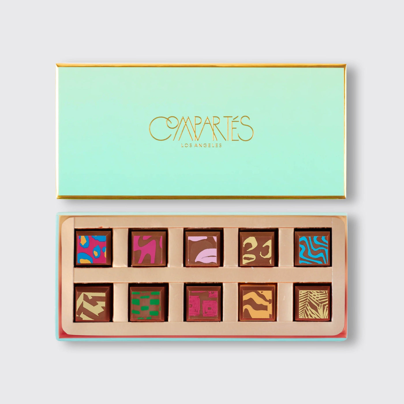 Box of Compartes Chocolate showcasing colorful, patterned artisanal chocolate squares