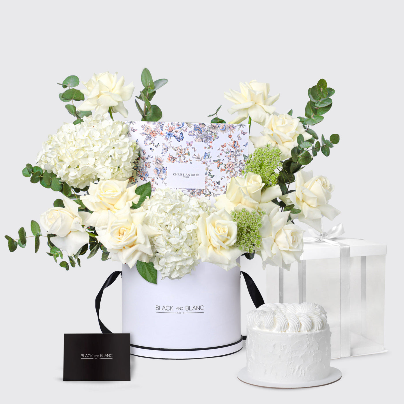 Elegant floral arrangement in a white box featuring white flowers and greenery from Dior