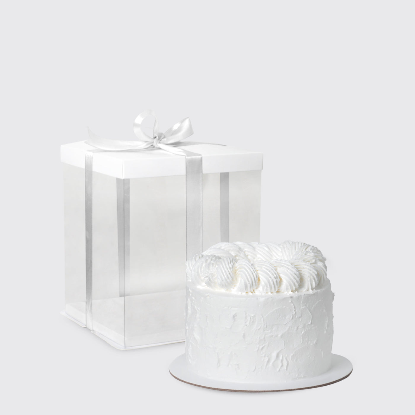 White frosted cake with swirls atop Dior Eternal Elegance Set