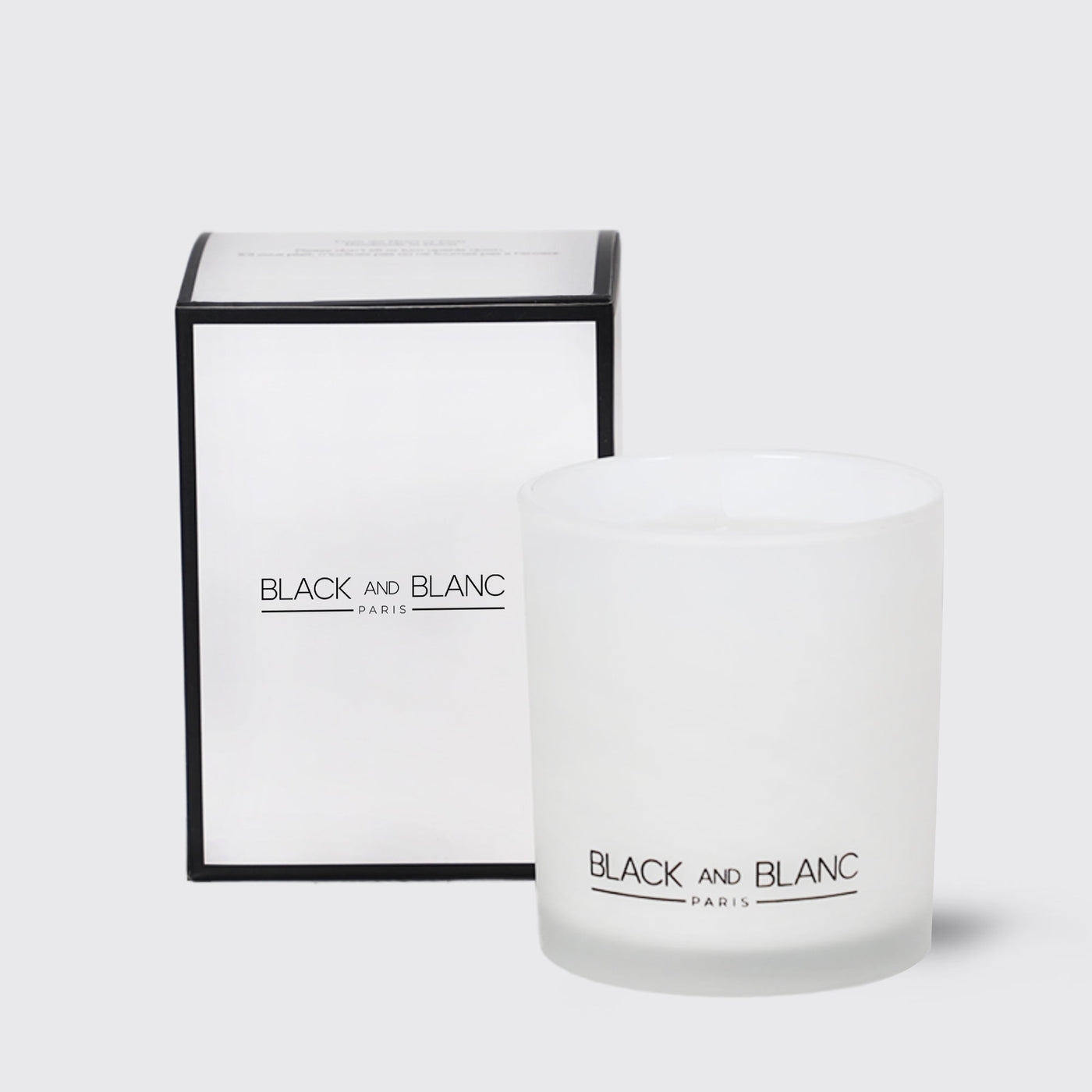 White scented candle with BLACK AND BLANC branding and its packaging box for Home Sweet Home