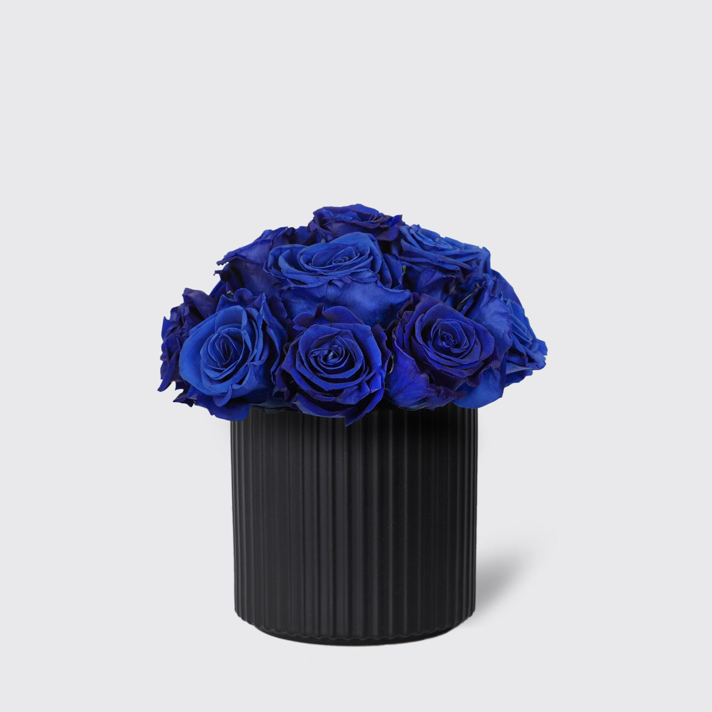 Vibrant blue roses in a sleek black vase from Infinity Blue Lagoon collection