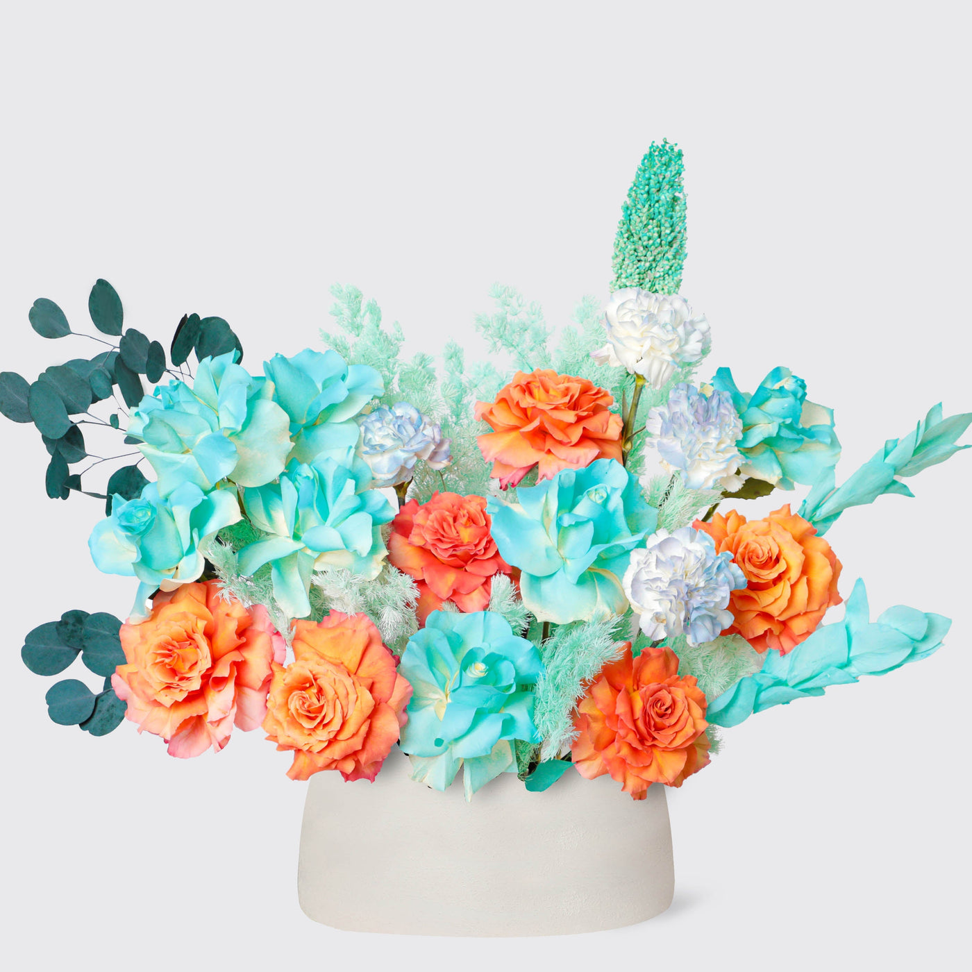 Colorful floral arrangement with orange roses and teal succulents in Mystic Harmony Vase