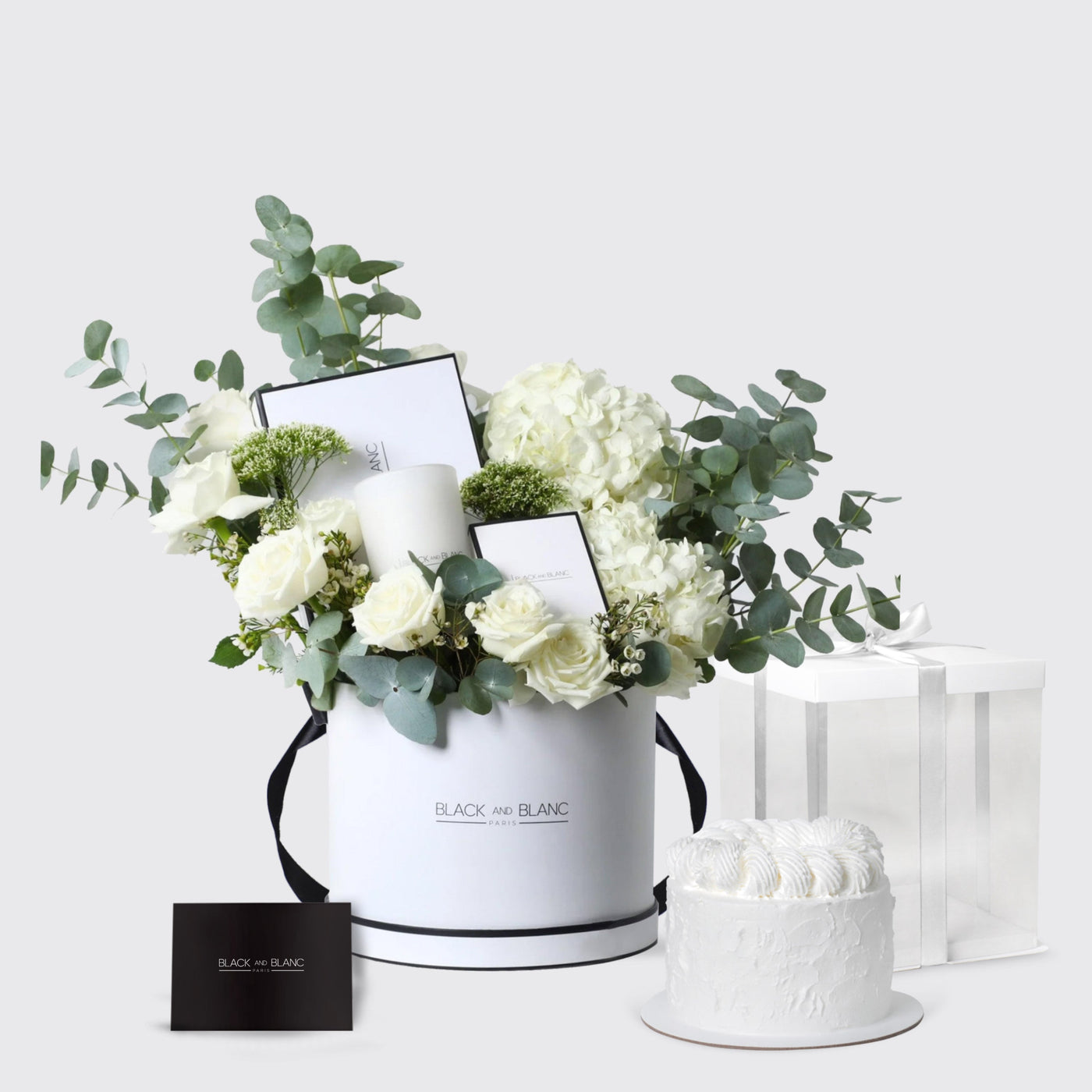 White cylindrical box with white flowers and greenery from the Pure Serenity Set