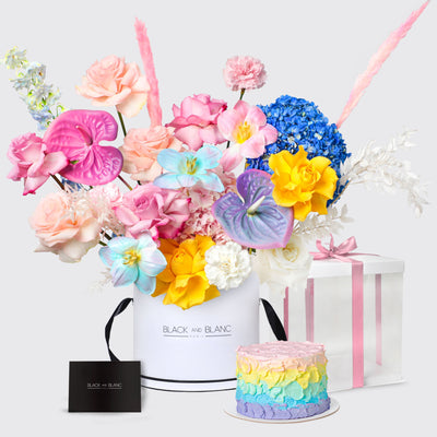 Colorful floral arrangement in a box with a rainbow cake and gift in the Rainbow Essence Set