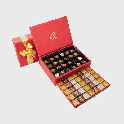 Luxurious royal gift box large with red chocolates and a gold bow, perfect for gifting