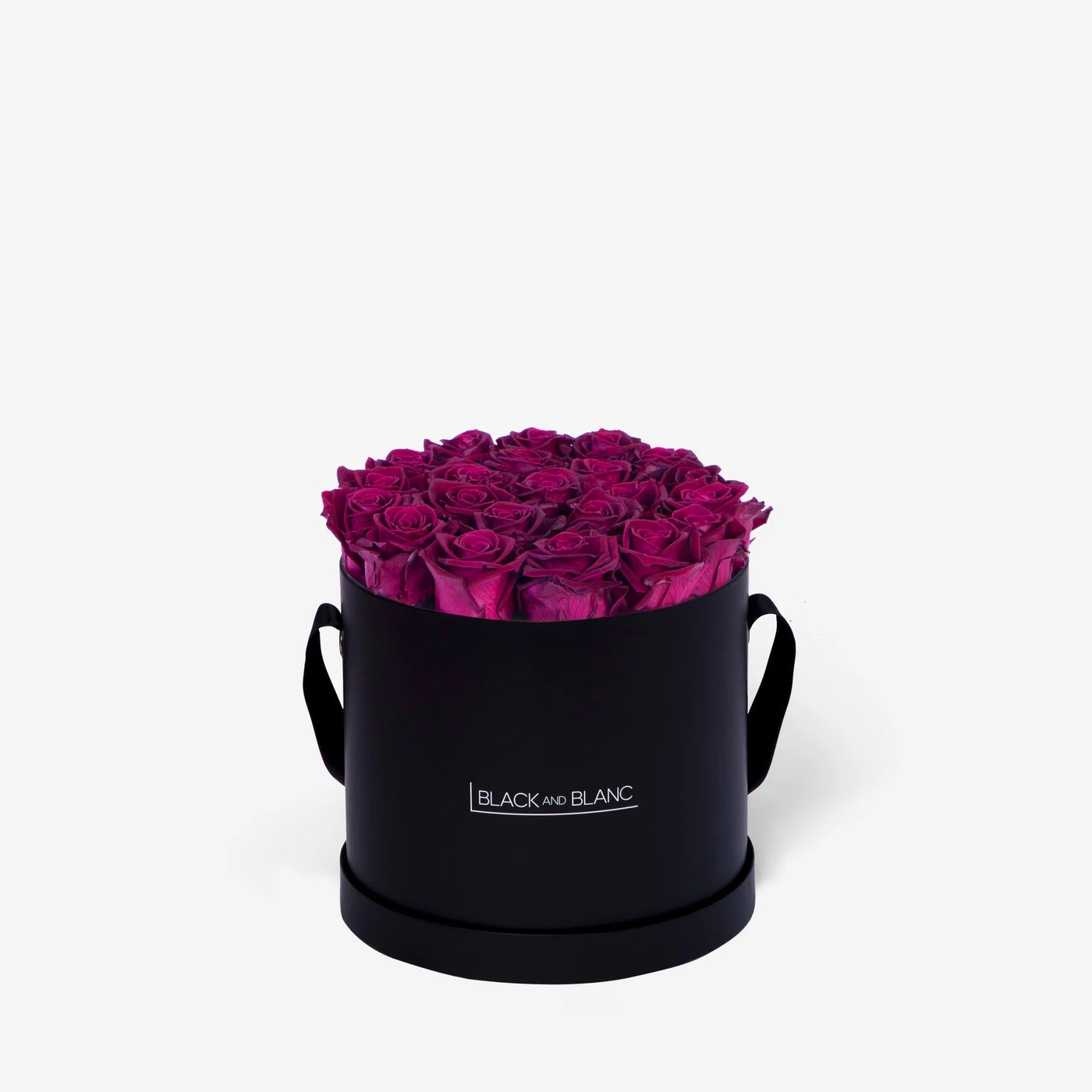 Black cylindrical box with vibrant magenta roses, perfect for flower delivery and beautiful arrangement