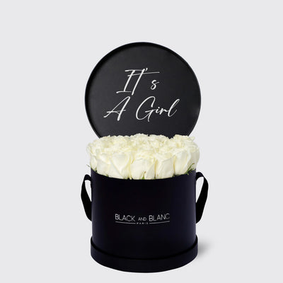 Circular black box with white roses and It’s A Girl sign from Texte De Fleur Fresh Flowers