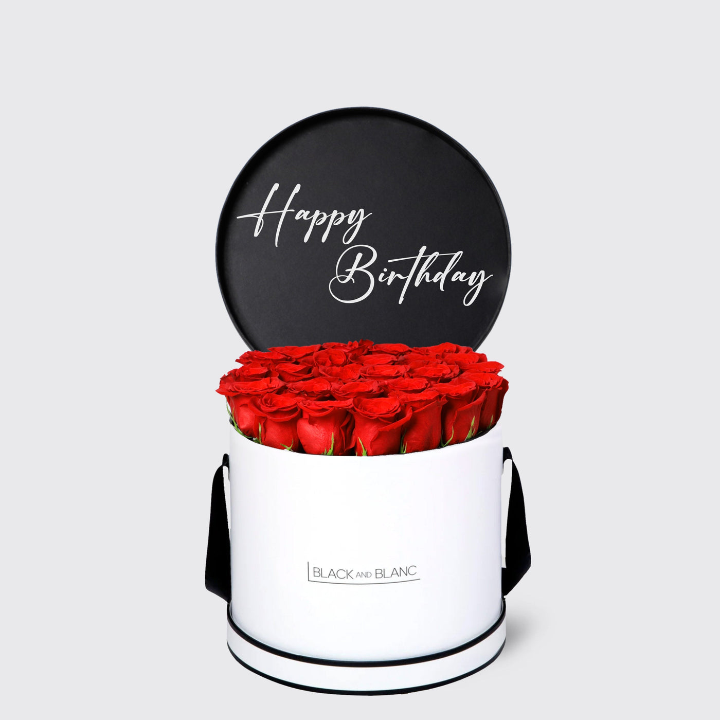 Cylindrical white box of red roses with black lid saying Happy Birthday from Texte De Fleur