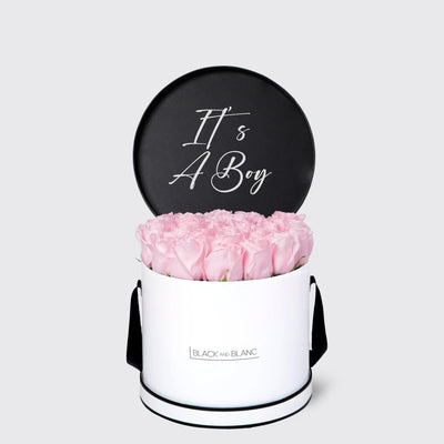 Circular white box of pink roses with a black It’s A Boy sign from Texte De Fleur