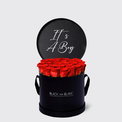 Circular black box with red roses and a sign saying It’s A Boy from Texte De Fleur