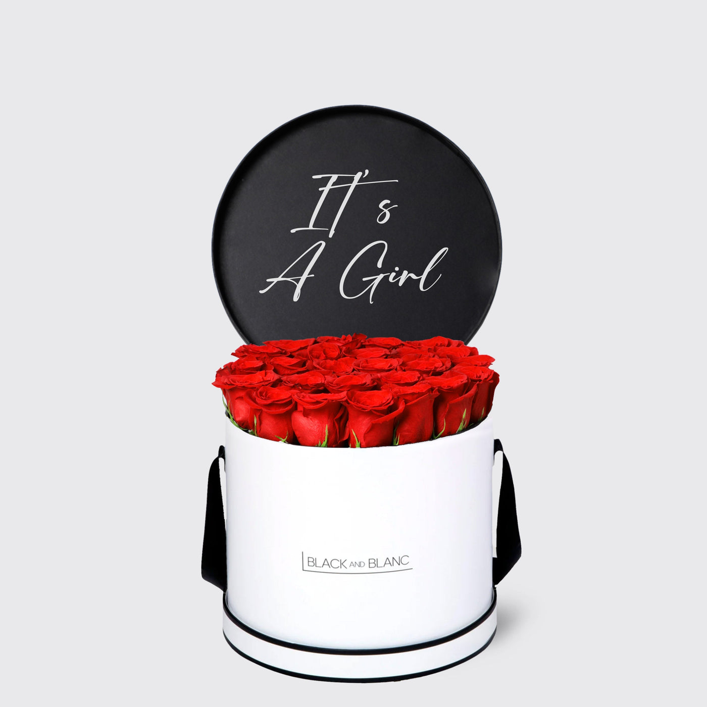 Cylindrical white box with red roses and black It’s A Girl sign from Texte De Fleur