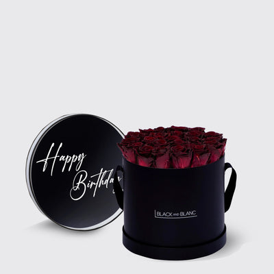 Elegant black round box of infinity roses with Happy Birthday lid design