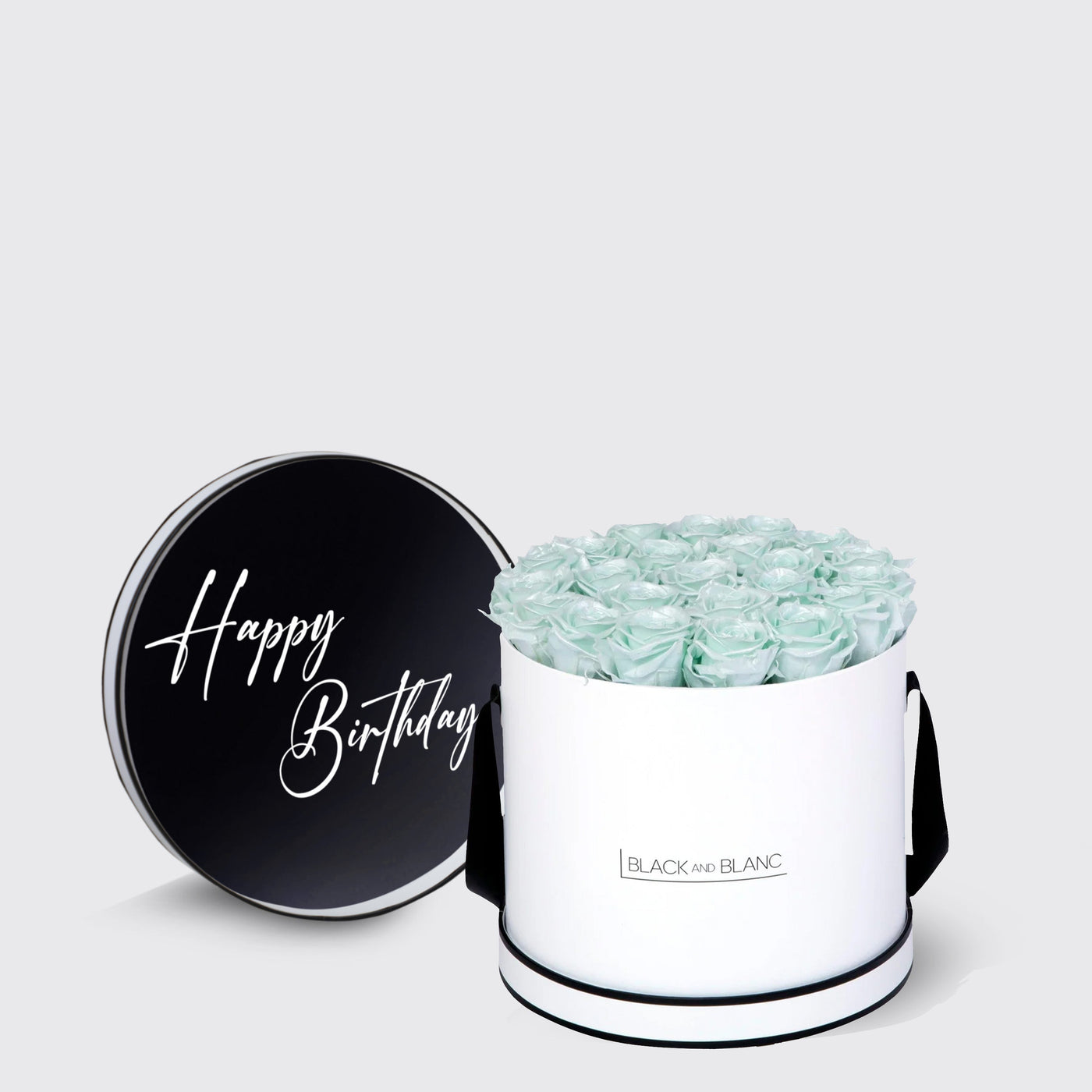 Cylindrical white box with pale green infinity roses and black Happy Birthday lid