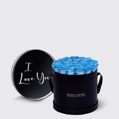 Circular black box of infinity roses with bright blue blooms and I Love You lid