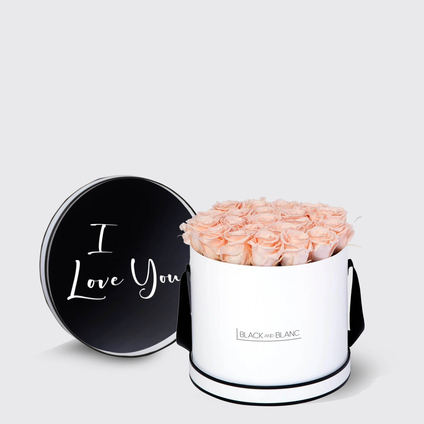 Circular white box with light pink roses and black lid saying I Love You, Infinity Roses