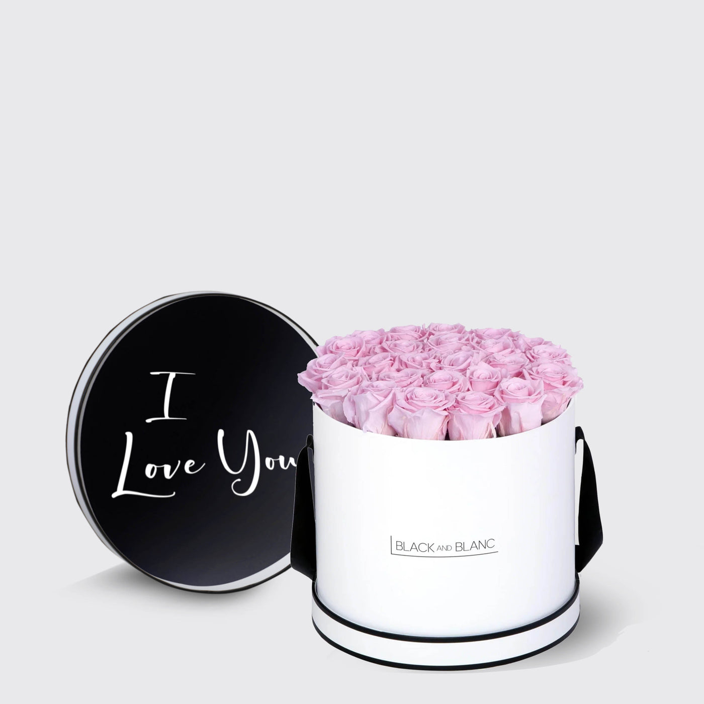 Elegant white cylindrical box of infinity roses with I Love You inscribed black lid