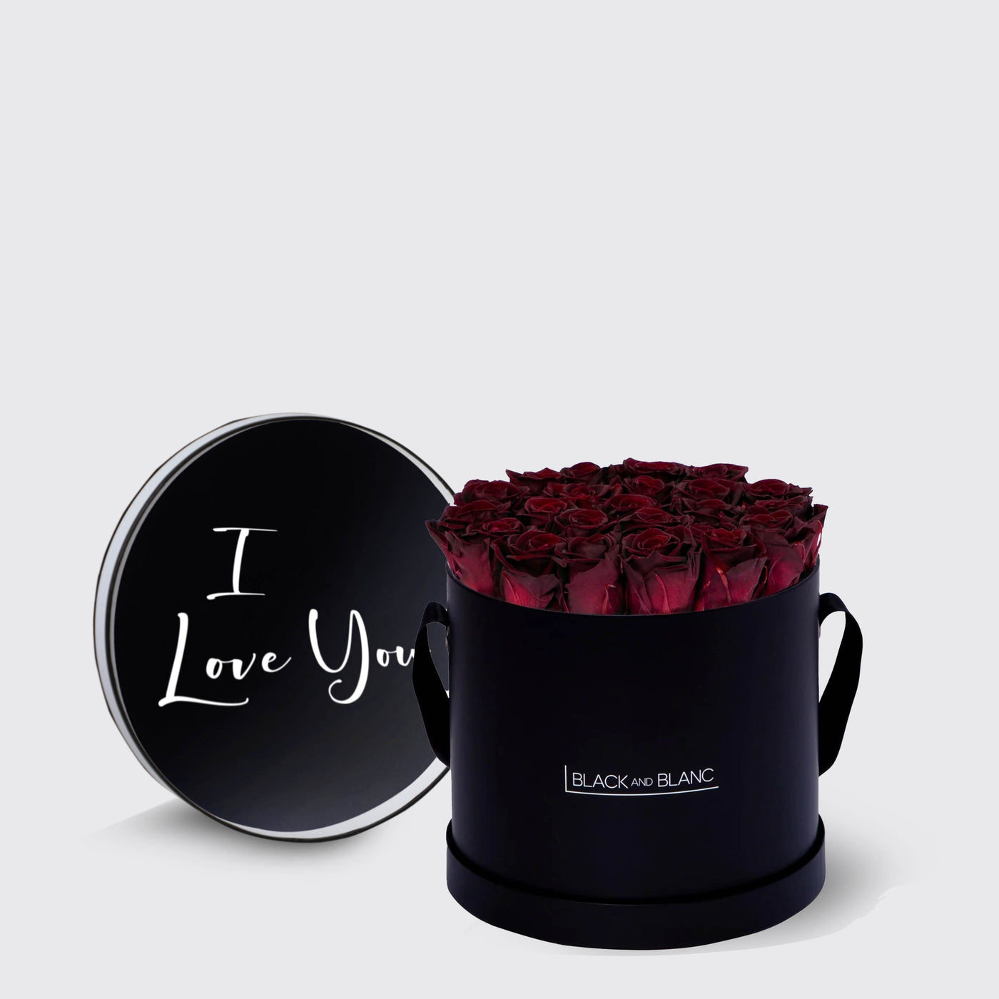 Circular black box of infinity roses with red blooms and I Love You in white script