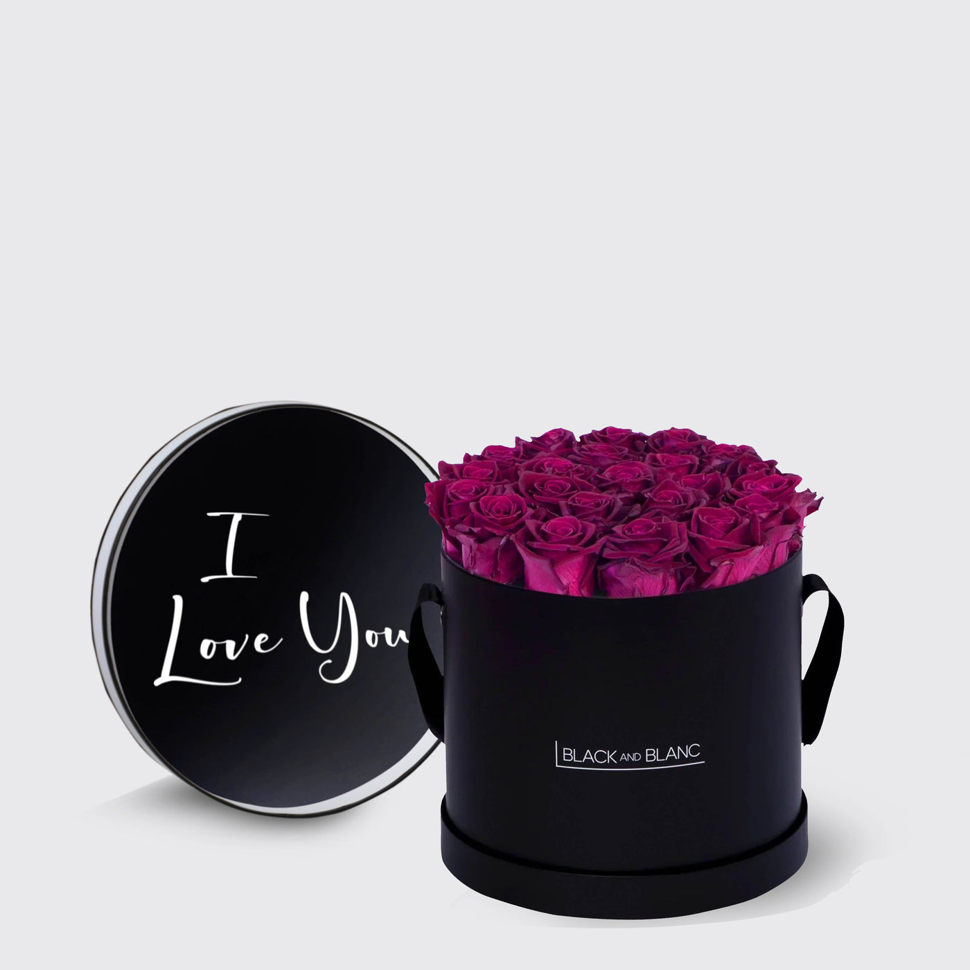 Elegant black round box filled with infinity roses and a lid saying I Love You