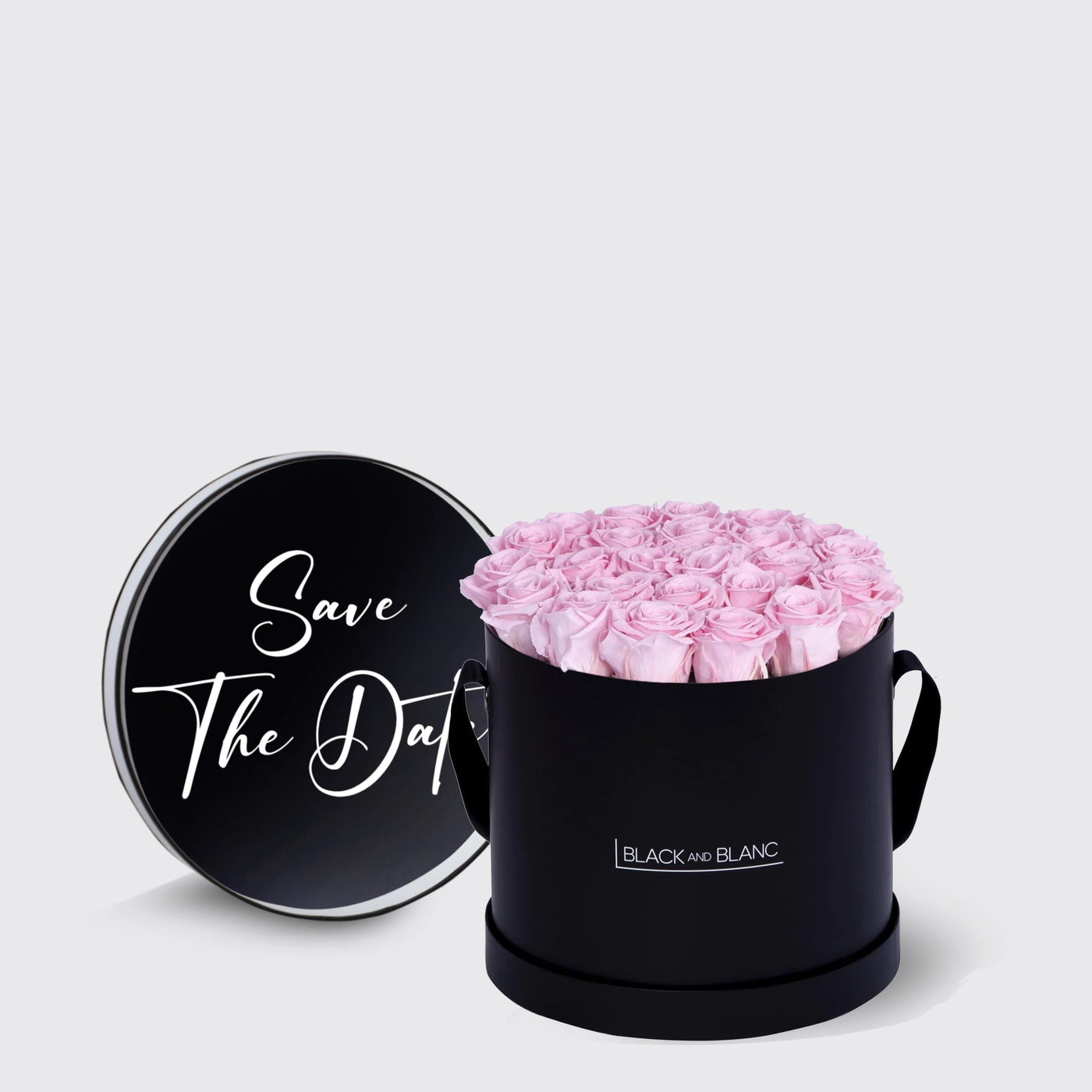 Black box filled with pink infinity roses, featuring a lid that says Save The Date