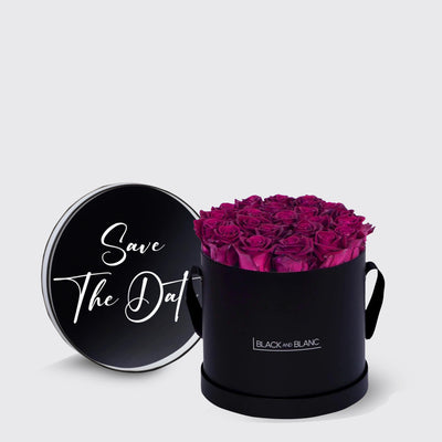 Elegant black box with fuchsia infinity roses and a Save The Date lid