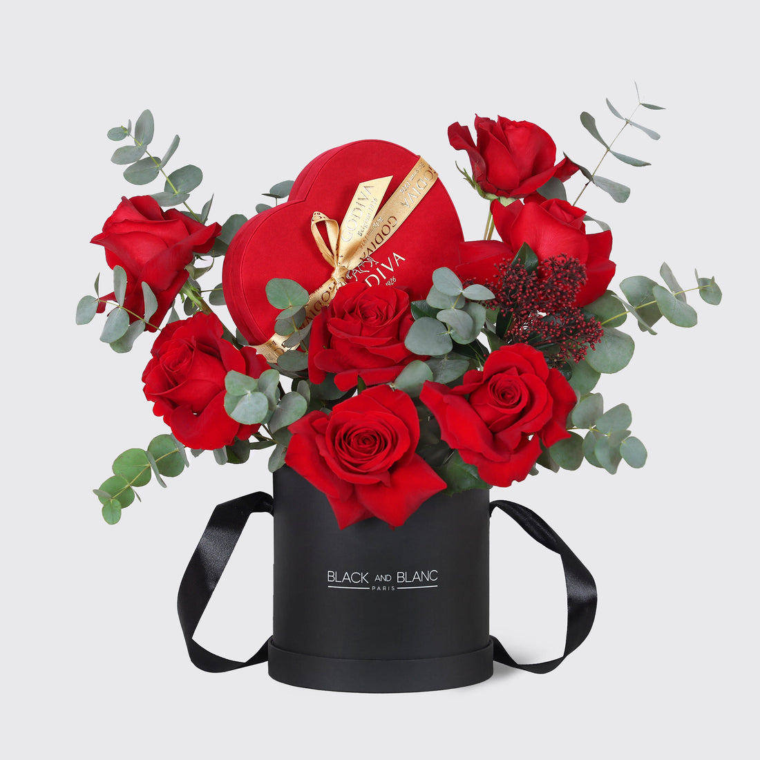 Velvet Heart Assortment Small – red roses and eucalyptus with a Godiva heart box in a black box